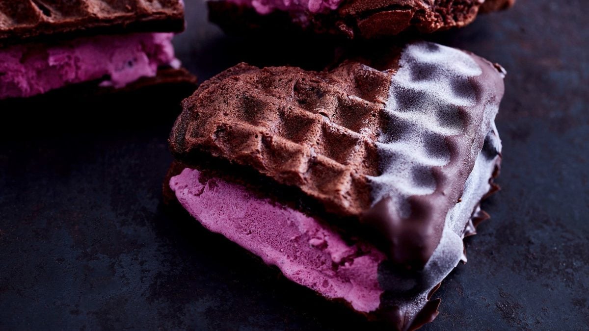 Dreimal Browniewaffel Eis-Sandwich auf schwarzem Tisch aus der Draufsicht.