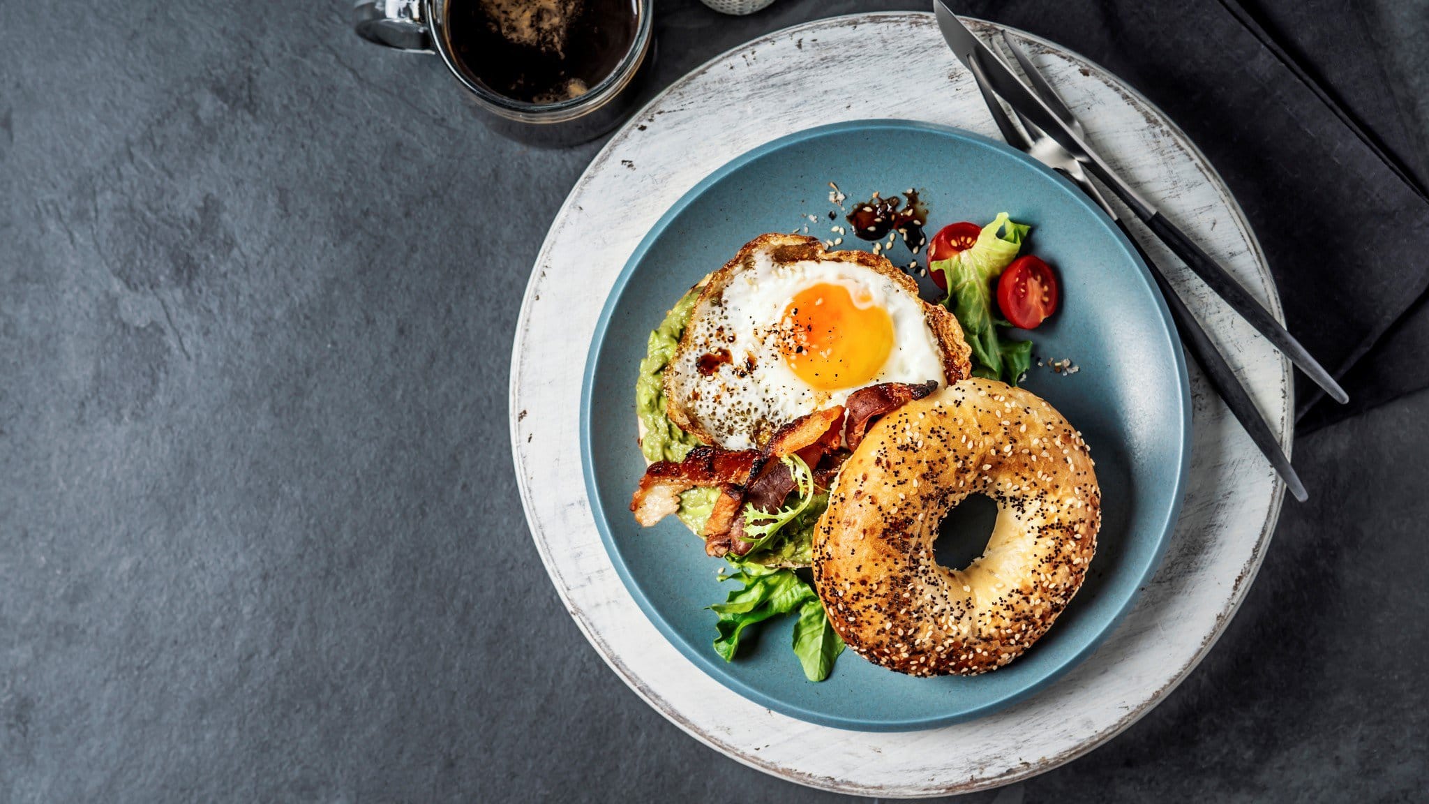 Bagel mit Spiegelei auf Teller serviert.