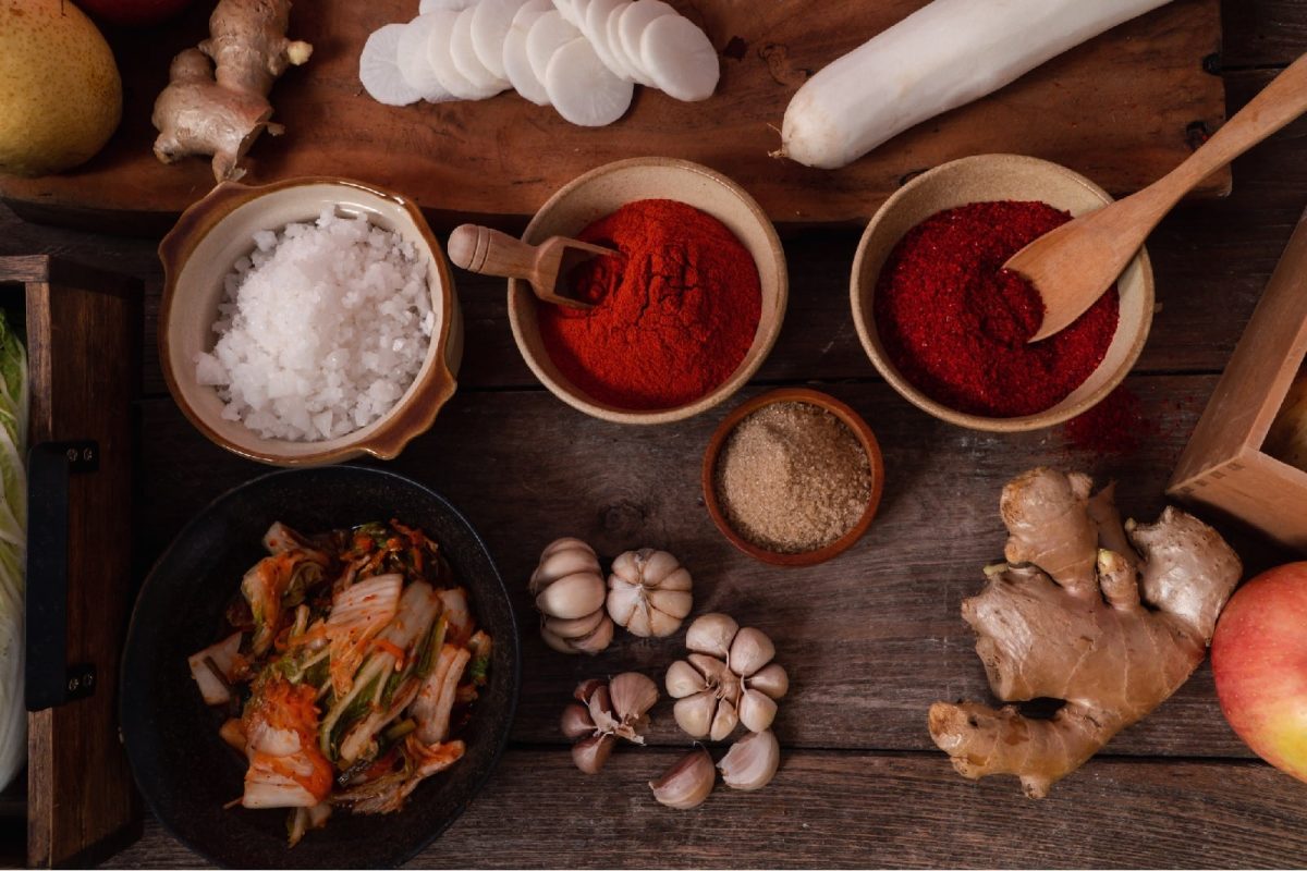 Eine Arbeitsfläche mit koreanischen Gewürzen, Ingwer, Knoblauch und Kimchi