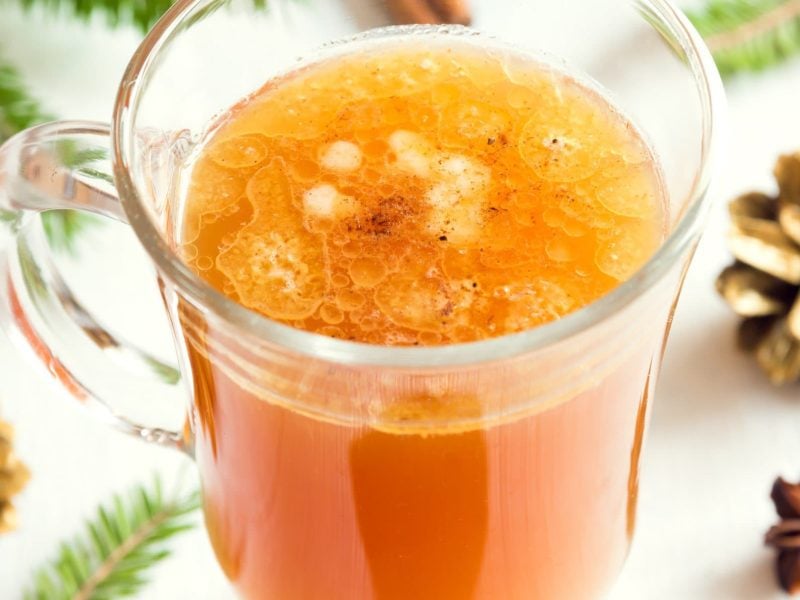 Grzanka polnischer Glüh-Vodka in kleiner Glastasse mit weihnachtlicher Dekoration Bild. Draufsicht.