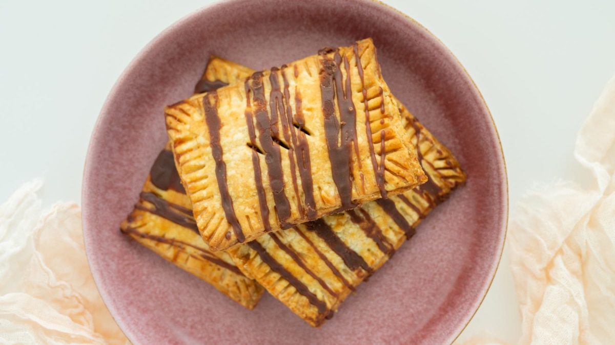 Vegane Pop Tarts mit Schokolade auf einem rosa Teller vor hellem Hintergrund.
