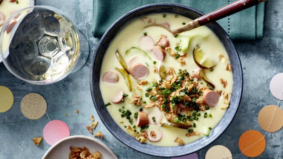 Eine Schüssel Hotdog-Suppe mit Röstzwiebeln und Schnittlauch in der Draufsicht.