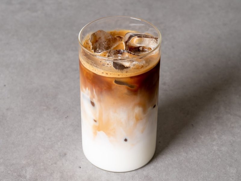 Ein Glas Raffaello Latte auf einem grauen Tisch.