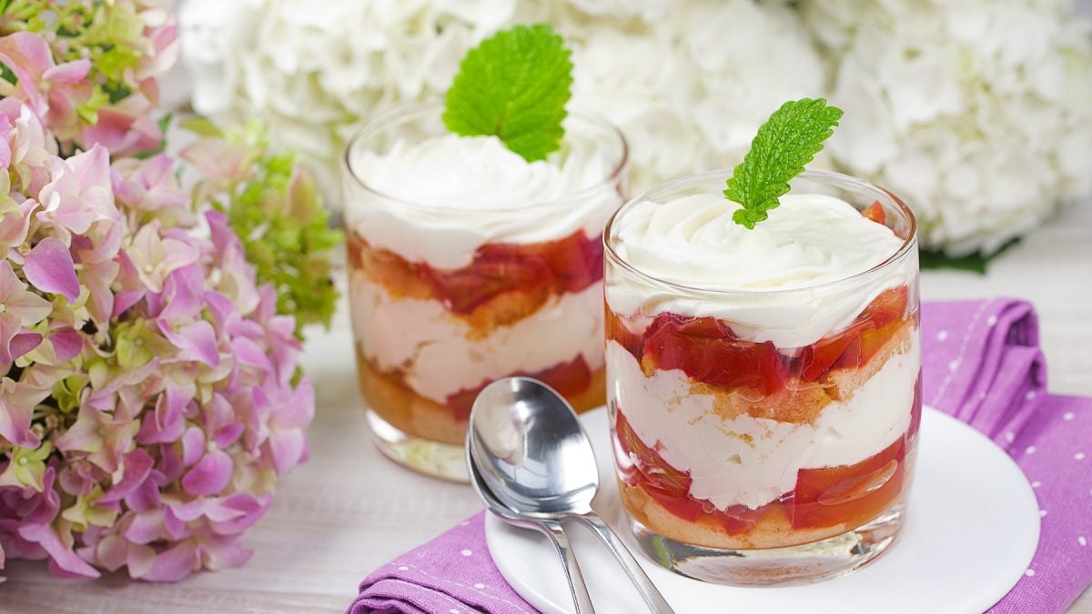 Rhabarber-Tiramisu in Gläsern und dekoriert mit einem Minzblatt.