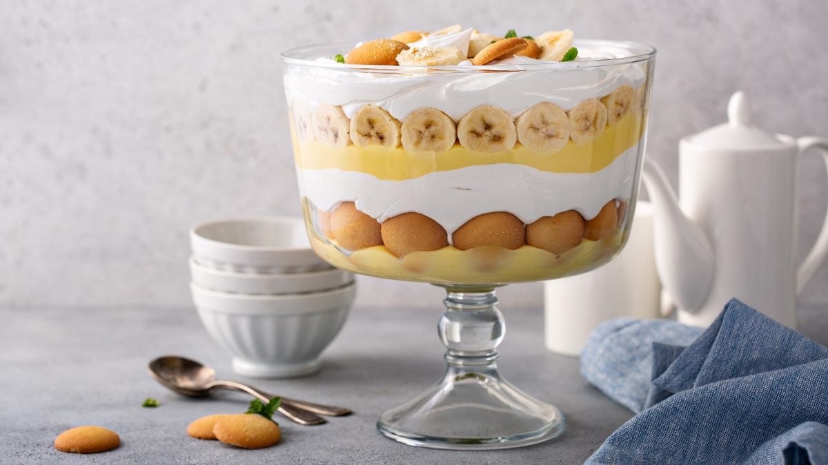 Banana Pudding Trifle in einer Schüssel. Daneben weißes Teeservice.