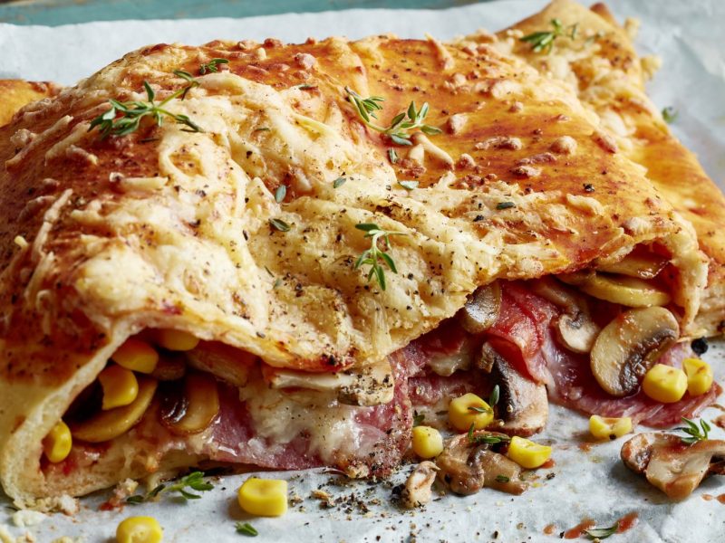 Pizza Calzone aus weißem Backpapier.
